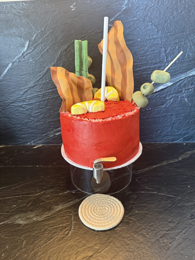 The Bloody Mary cake from the front, with its tap and a coaster