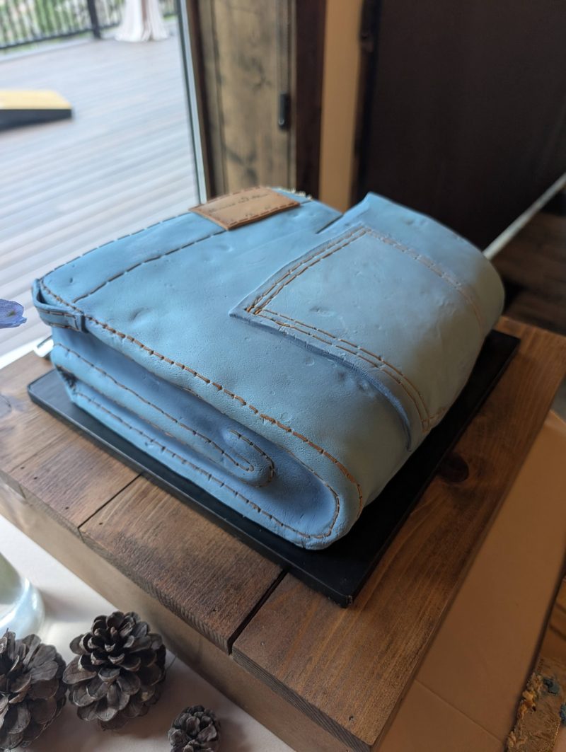 Close view of the folded-jeans cake, showing the stitched seams and back pocket